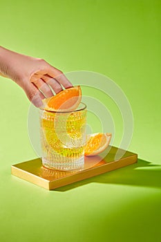 Hand of man is picking up a orange slice. Front view, copy space