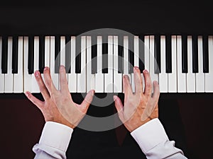 Hand man playing piano. Classical music instrument. Top view