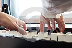 Hand man playing piano. Low angel view.  Classical music instrument