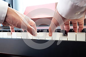 Hand man playing piano. Low angel view.  Classical music instrument