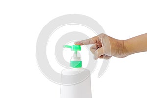 Hand of man is pressing on the green pump of white plastic bottle