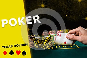 Hand of man raising aces from green table. Stacks of chips standing nearby, black background. Poker, texas holdem, card