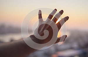 Hand of a man reaching to sky