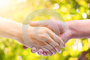 Hand man Shake hands on green bokeh background