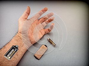 Hand of man with slot for charging batteries