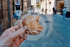 Hand of a man in the street holding a pastissets, casquetes, dough pasties with a semicircular shape. The original Aragonese photo