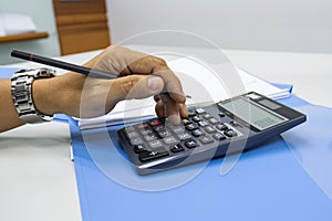 Hand of man use use calculators with documents of income, expenses, concept of life at work