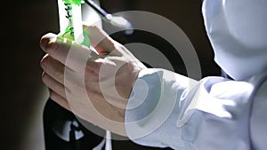 Hand man using corkscrew to open a bottle of wine. Black background