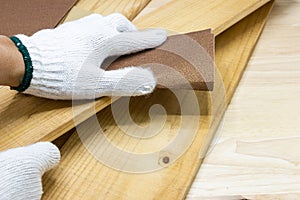 Hand of Man using sandpaper