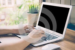 Hand of man working laptop computer with blank screen, work from home for social distracting is new normal