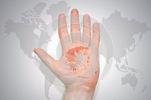 Hand with map of greece on the gray world map background