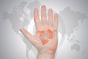 Hand with map of middle east on the gray world map background