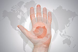 Hand with map of romania on the gray world map background