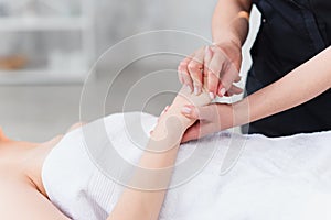 Hand massage. Physiotherapist pressing specific spots on female palm. Professional health and wellness acupressure photo