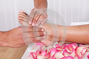 Hand Massaging Foot In Spa