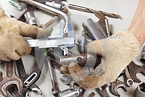 Hand of master measure the part with a calliper in workshop