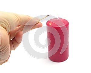 Hand, match and candle