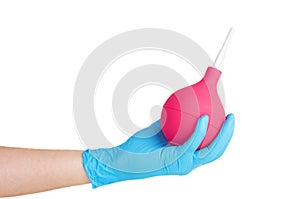 Hand in medical glove hold big pink clyster