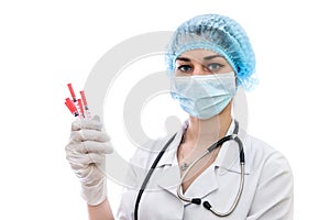 Hand in medical glove holding syringes isolated on white