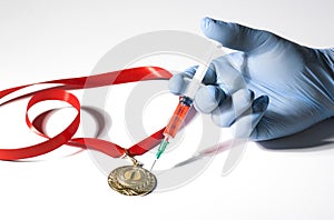 A hand in medical glove stabs a gold medal with popular red steroid in syringe on a white background