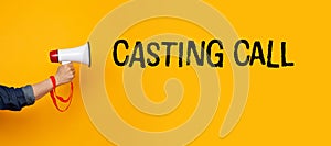 Hand with a megaphone and a casting call text