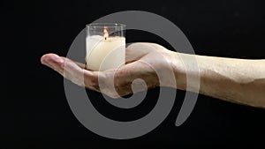 In the hand of the men glows a candle of memory