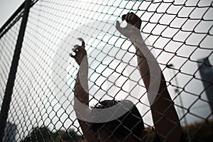 Hand with metal fence, feeling