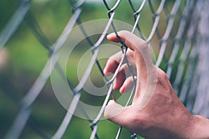 Hand with metal mesh fencing , freedom and imprison concept photo