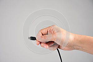 Hand and micro usb cable  white background