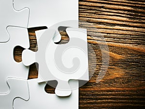 Hand with missing jigsaw puzzle piece. Business concept image for completing the final puzzle piece.