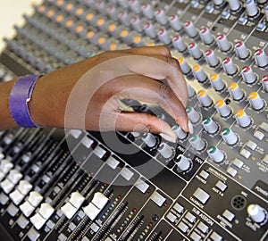 Hand on a mixing desk