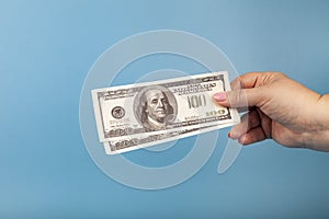 Hand with money. Dollars. Blue background