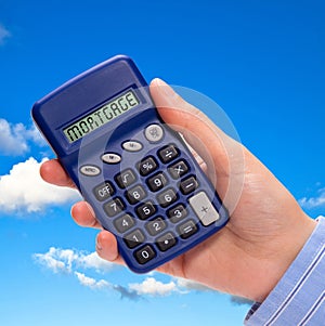 Hand with mortgage calculator