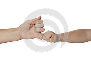 Hand of mother and child hold each other by little fingers, peace or swear. Fingertip agreement isolated on white background