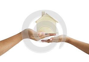 Hand of mother giving the wooden house model to daughter metaphor the legacy of real estate concept select focus shallow depth of