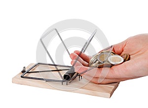 Hand and mousetrap with money