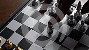 Hand moving chess pawn defeat enemy on chessboard