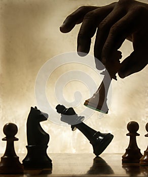 Hand moving chess piece