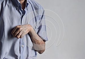 Hand muscle rigidity and finger flexion of Asian man photo