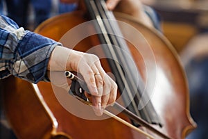 The hand of a musician playing the cello