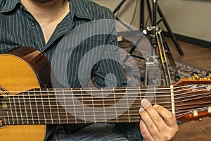 Hand of a musician playing a fret with eight strings