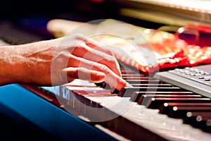 Hand of musician playing keyboard