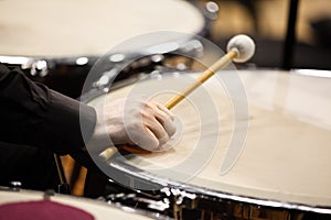 The hand of a musician playing on a timpani