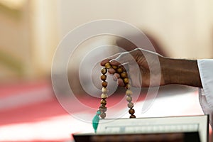 Hand of muslim black man people praying with mosque interior background