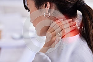 Hand, neck and injury with a business woman to holding her back in pain while working in the office. Medical, posture