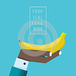 Hand of negroid businessman holds banana icon