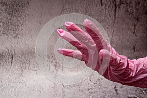 hand with nitrile gloves on gray background