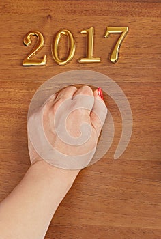 Hand and numbers 2017 on door - new year background
