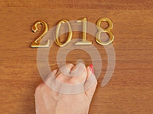 Hand and numbers 2018 on door - new year background