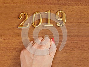 Hand and numbers 2019 on door - new year background